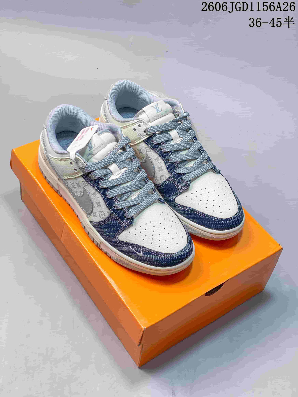 Pair of white low-top sneakers with blue patterned panels and gray laces.