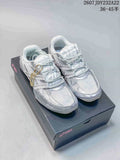 White ASICS Hypersync sneakers displayed on a branded shoebox, showing padded tongues, layered panels, and low-top construction.
