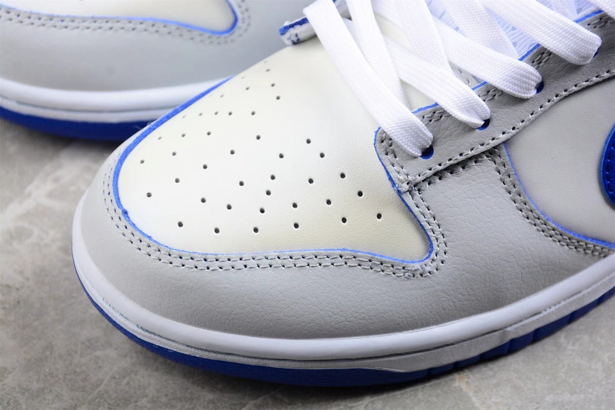 Close-up of the perforated white toe box and layered panel stitching.