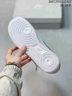 Close-up of the white outsole showing concentric circular traction patterns and embossed Nike branding.