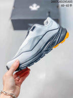 Side profile of the white and gray sneaker showing layered panels, a black midsole, and orange outsole accents; style code 2607GHD295A05 and size range 40–45 are overlaid.