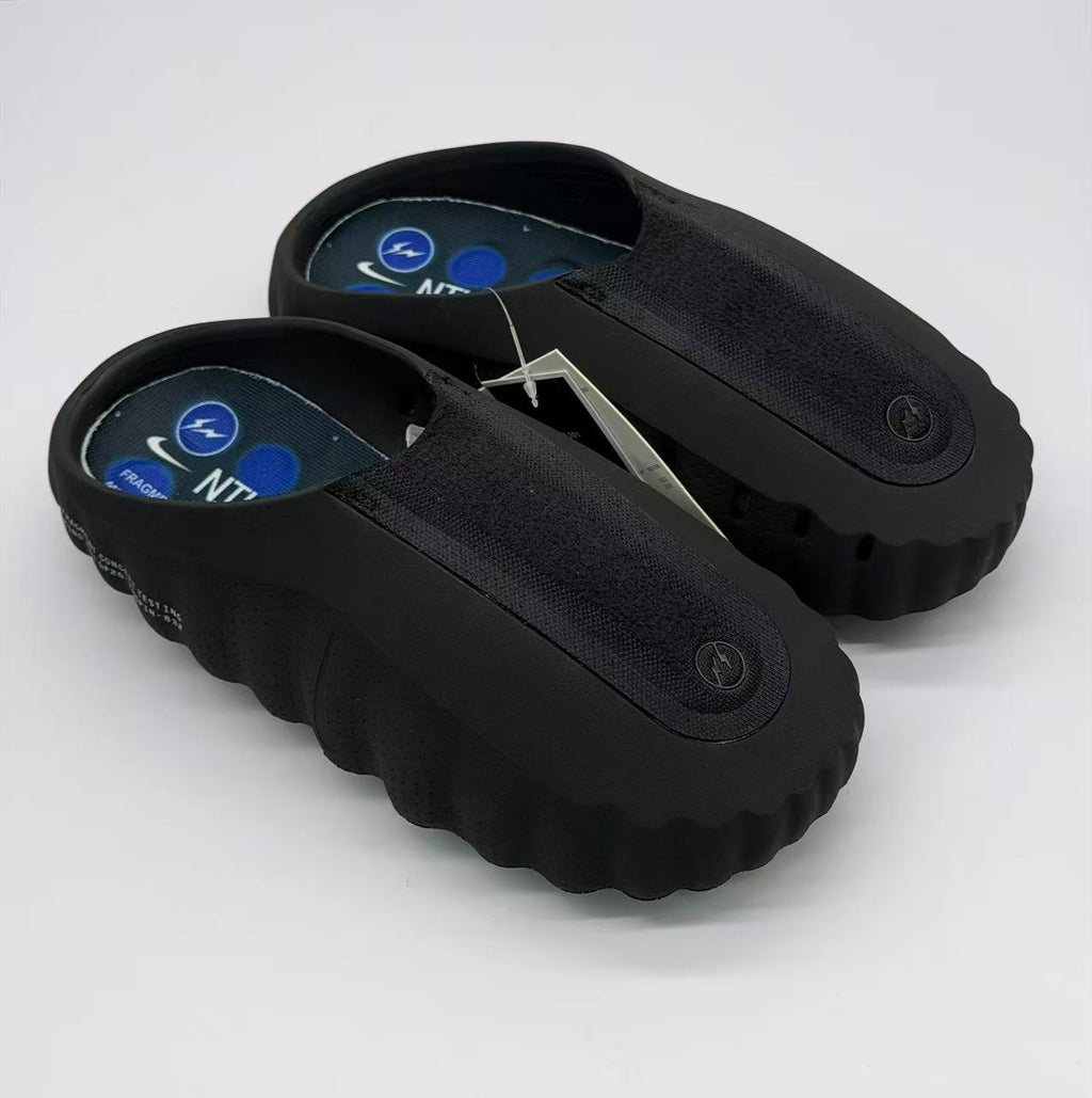 Top three-quarter view of the pair showing the open heel, textured uppers and blue footbed graphics.