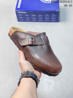 Dark brown closed-toe sandal with an adjustable buckle and open heel, shown beside a Birkenstock-branded box.