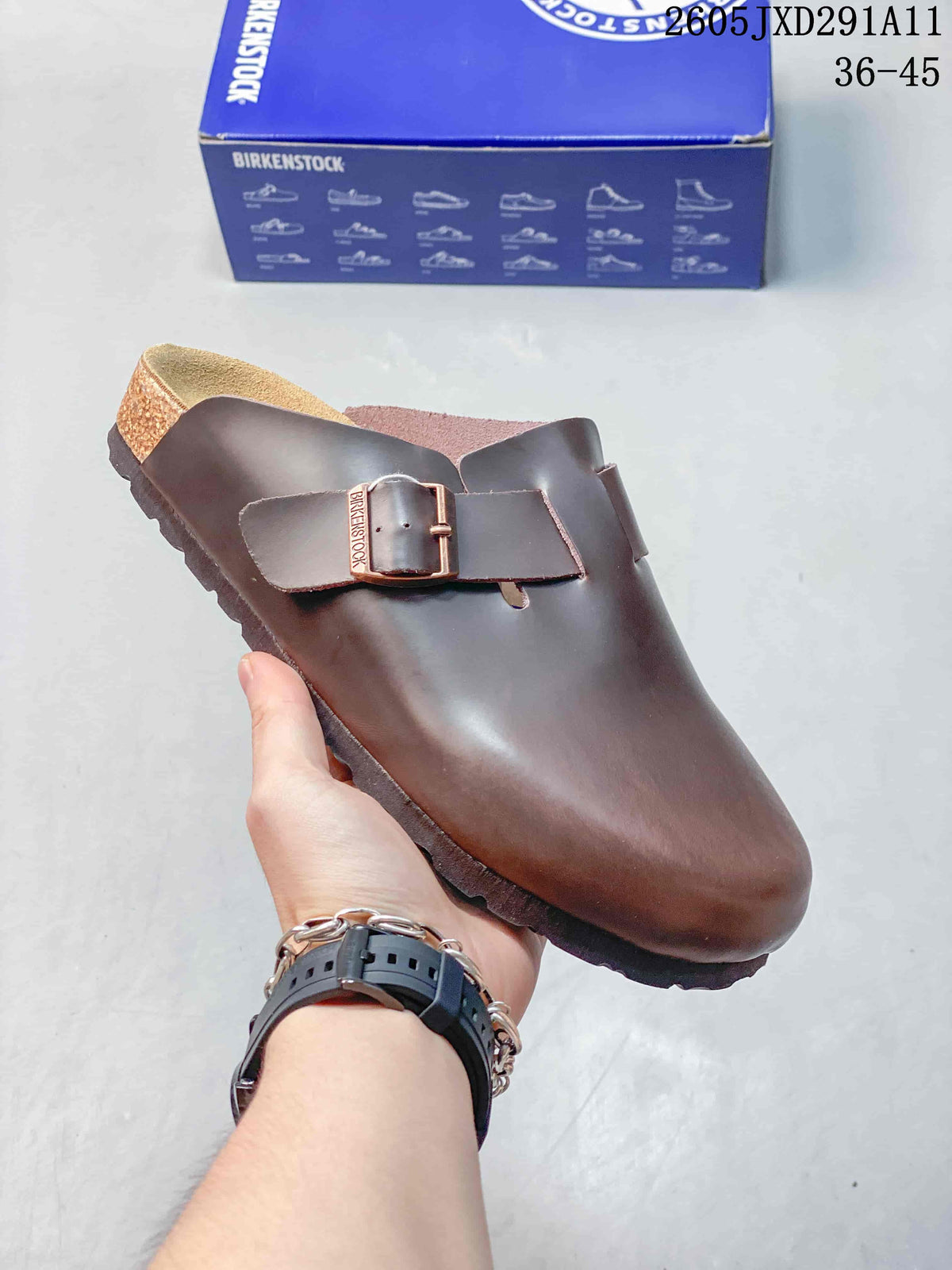 Dark brown closed-toe sandal with an adjustable buckle and open heel, shown beside a Birkenstock-branded box.