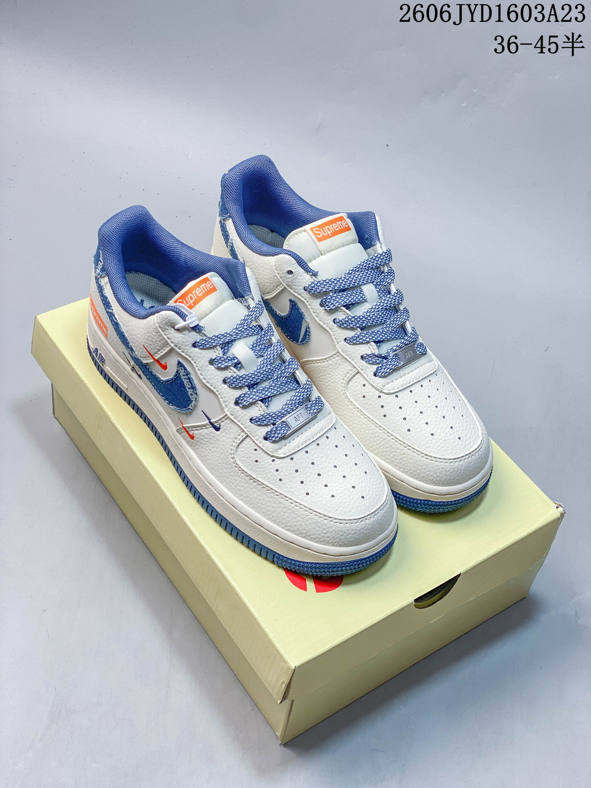 Pair of white and blue low-top Air Force 1 sneakers shown from above on a box