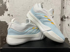 Pair of white, light blue, and yellow Adidas Dame 9 basketball shoes displayed together