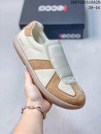 Angled side view of a cream and tan ECCO sneaker with visible branding at the heel.