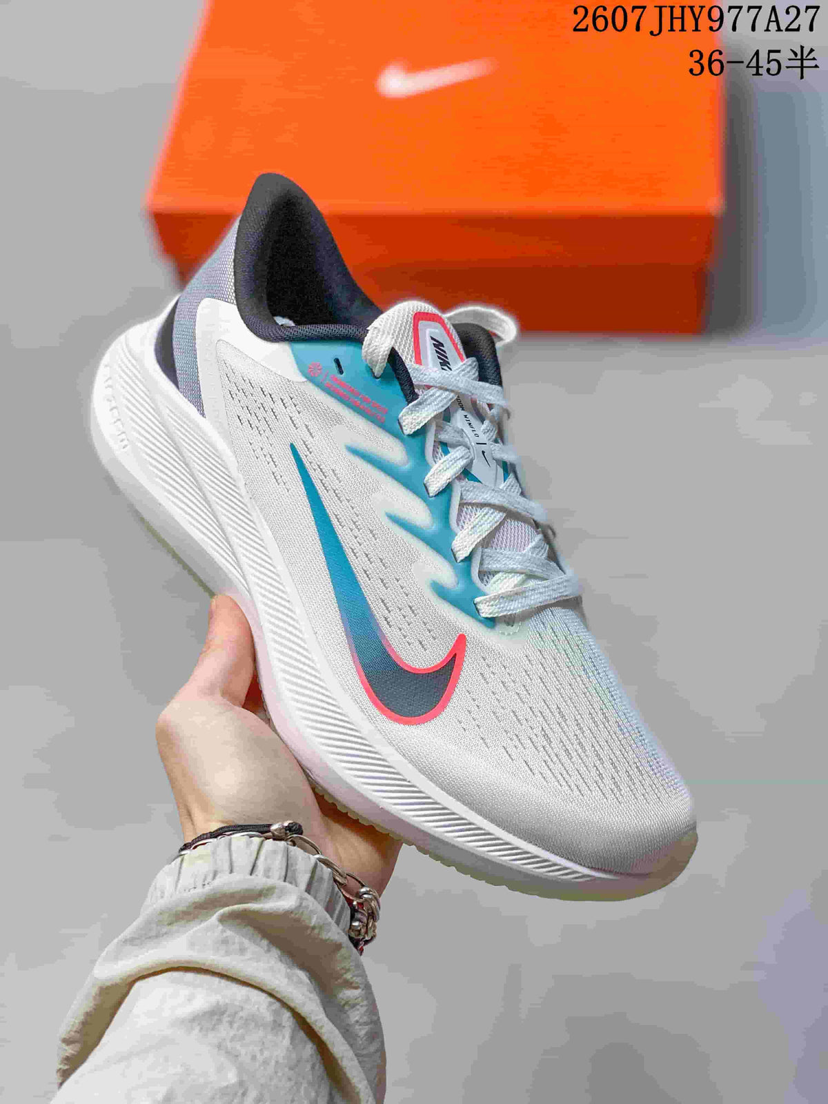 Angled side view of the white Nike Zoom Winflo 7 shoe with blue side detailing and a translucent outsole edge.