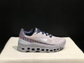 Side view of silver-gray and purple On Cloud X sneakers with a segmented outsole