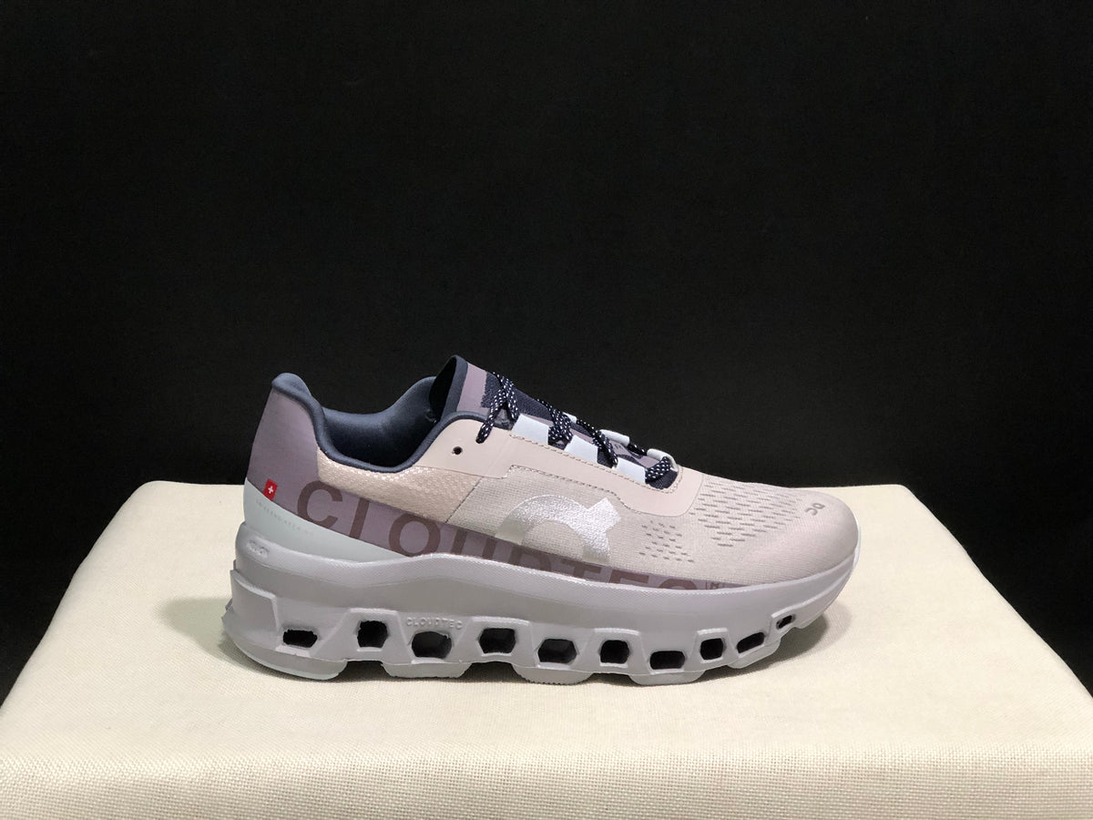 Side view of silver-gray and purple On Cloud X sneakers with a segmented outsole