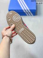 Close view of the patterned gum-colored rubber outsole with circular traction details and Adidas branding.