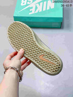 Close view of the sneaker outsole showing a honeycomb-like textured tread and gum-toned rubber.