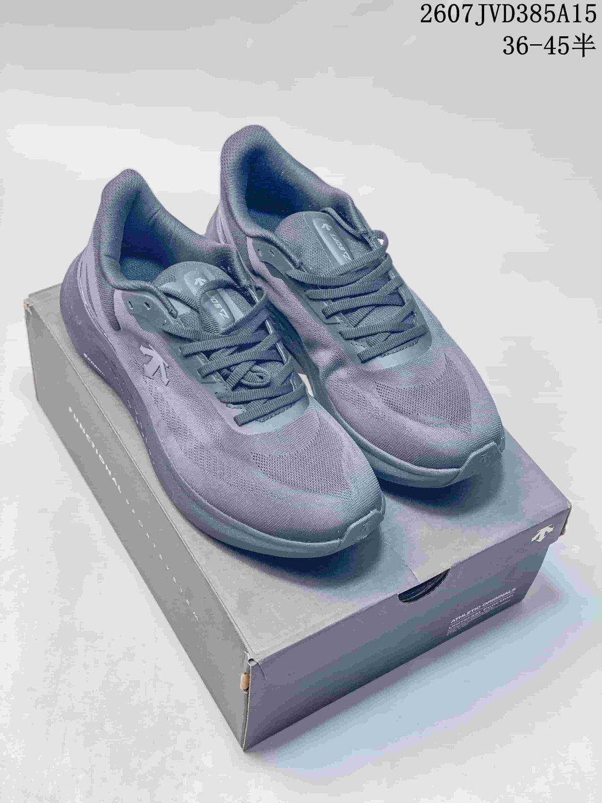 Grey Descente EASE WIRE sneakers displayed on a shoe box, with style code and size range visible above.