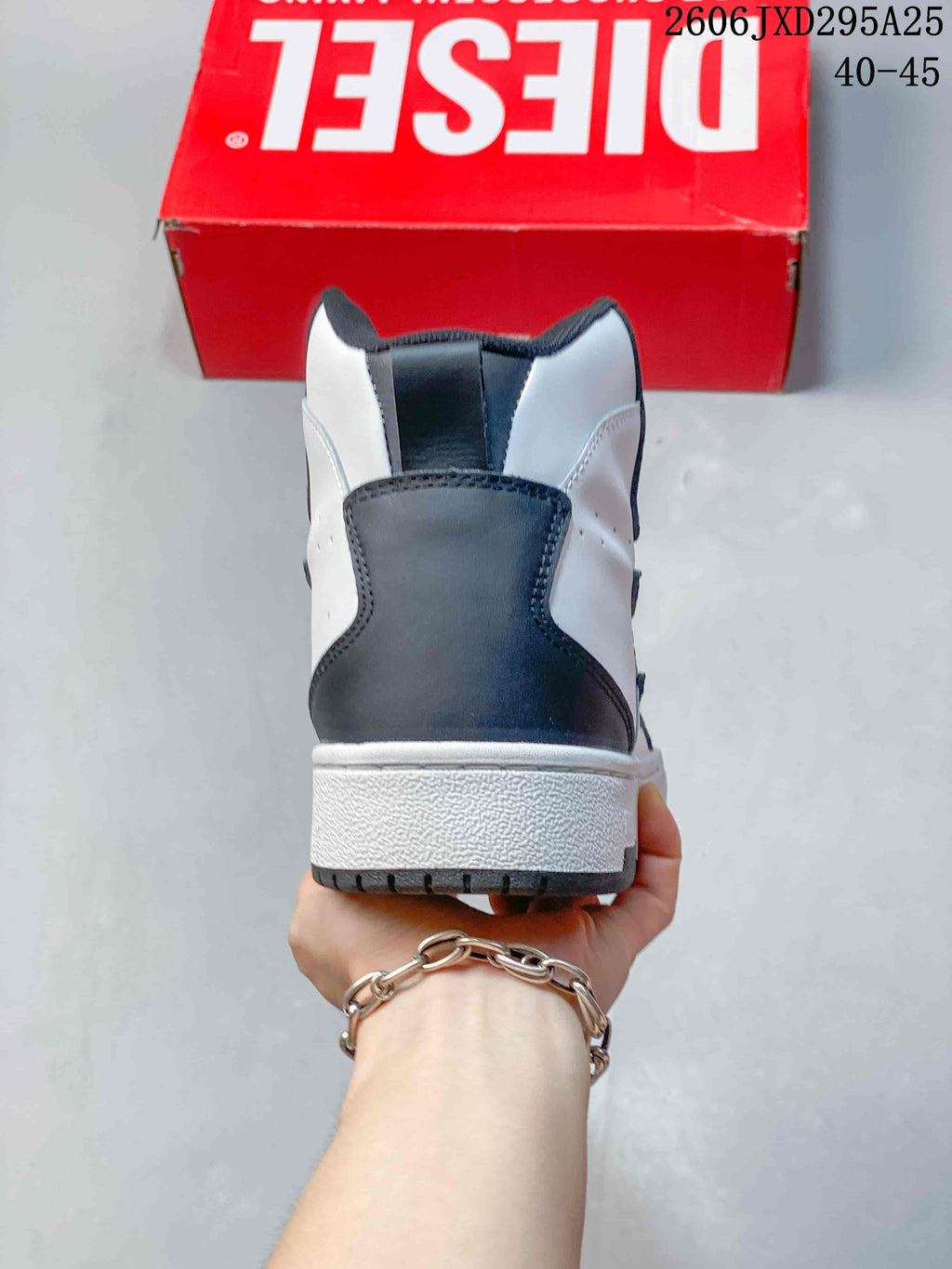 Rear view of a white and dark gray high-top sneaker
