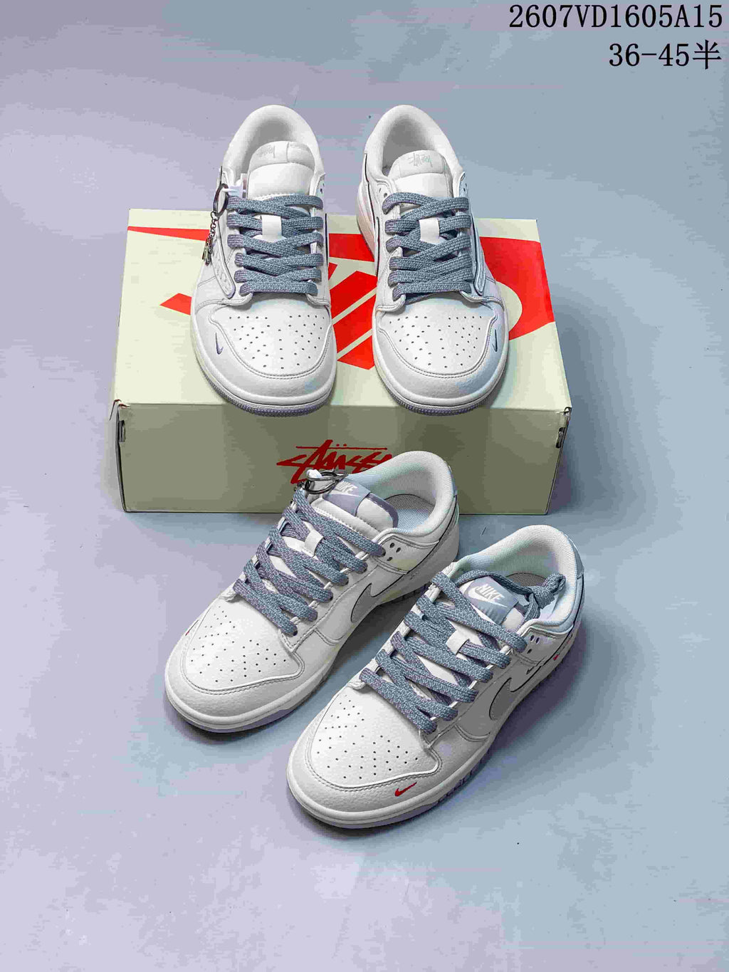 Multiple views of white and grey low-top sneakers arranged around a Nike-branded shoe box.