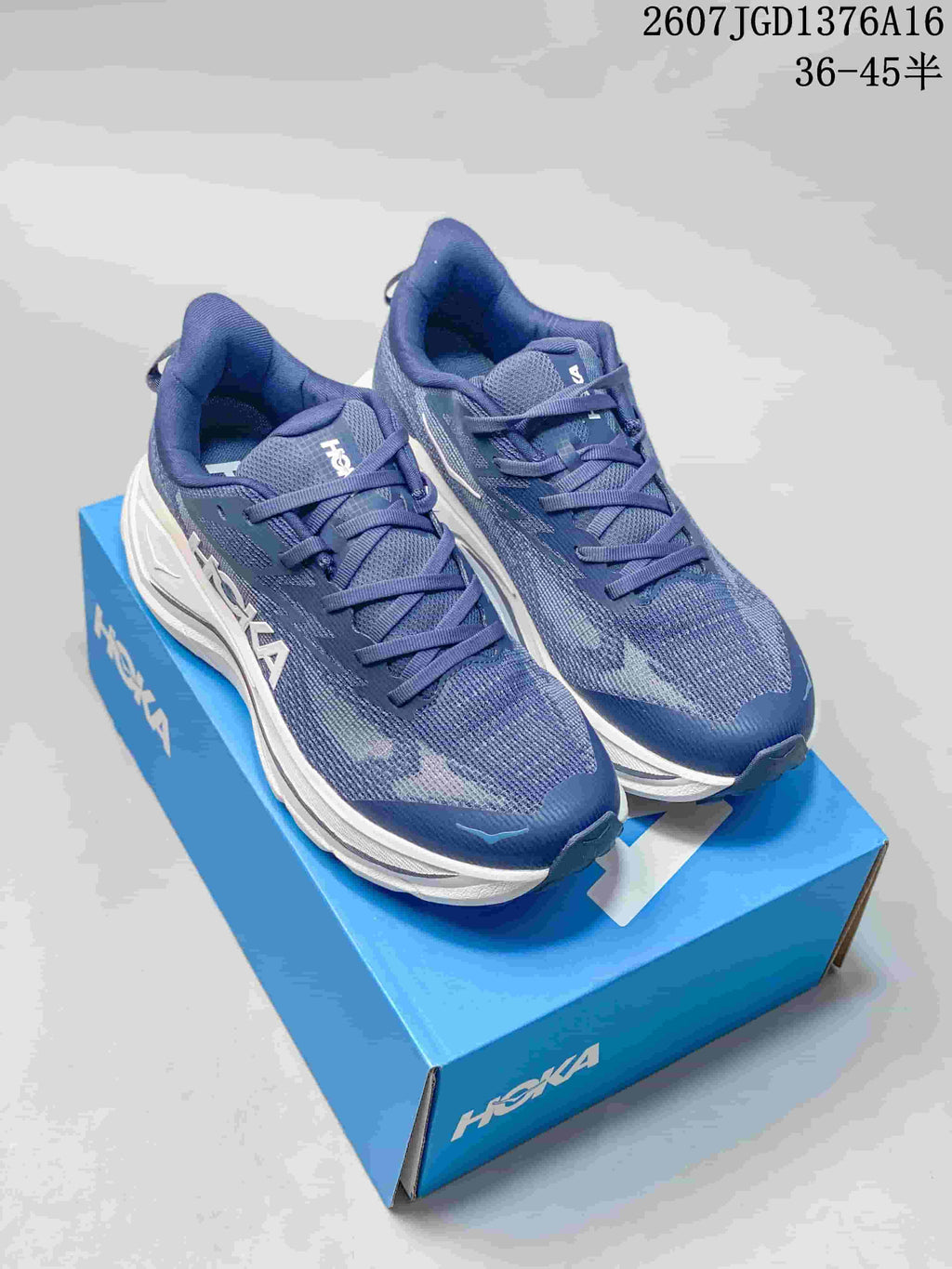 Pair of blue HOKA Challenger 8 running shoes displayed on a blue shoe box, with the advertised size range visible above.