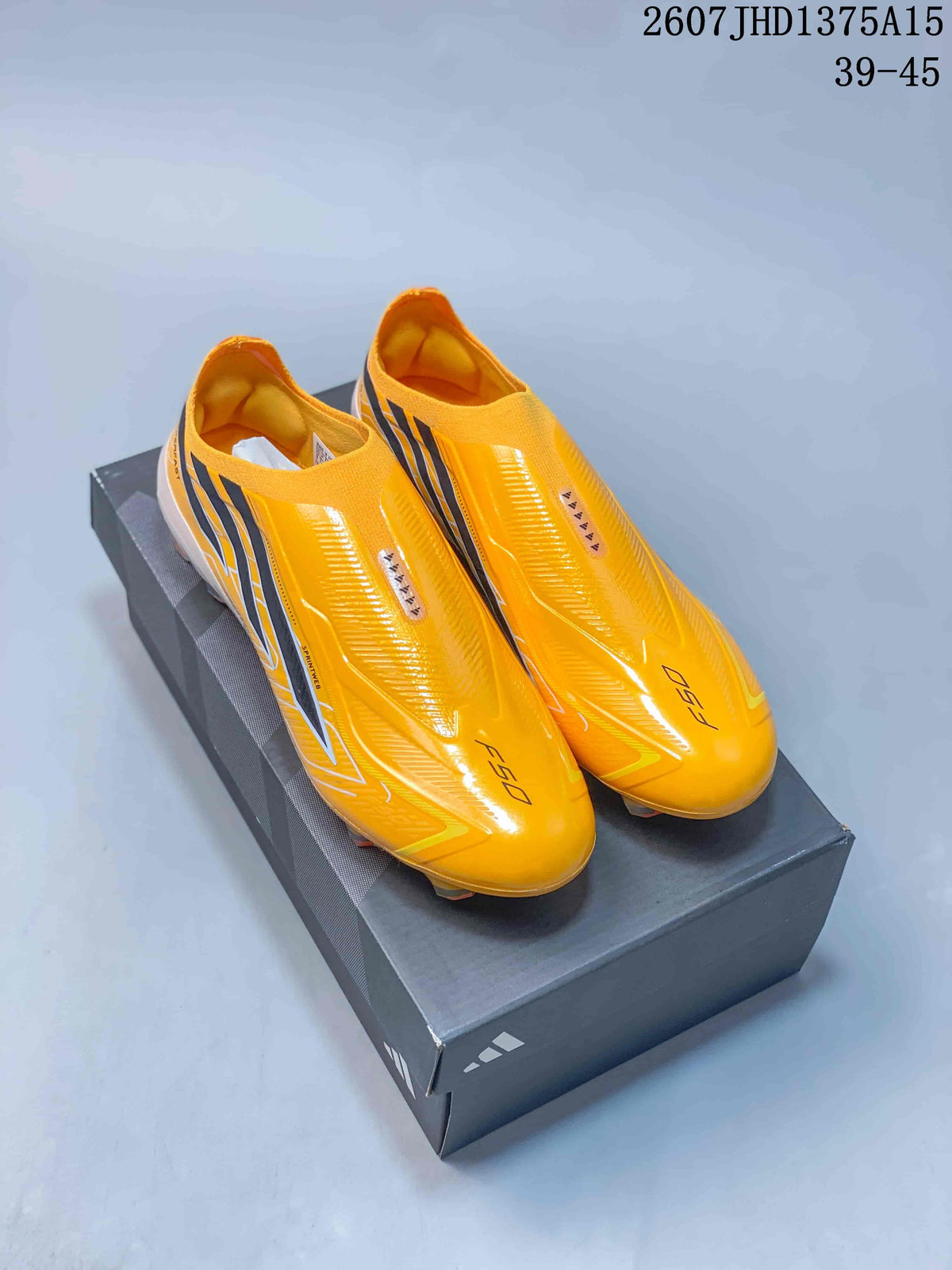 Yellow adidas F50 Elite football boots displayed on a black shoebox, showing the slip-on collar and studded outsole.