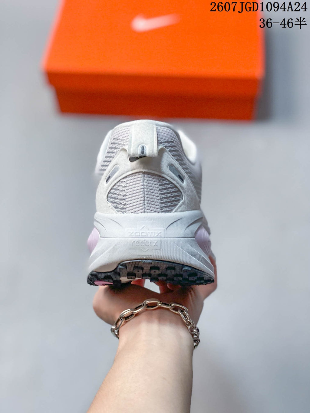 Rear view of the sneaker showing the padded heel, textured upper, sculpted midsole, and black outsole.