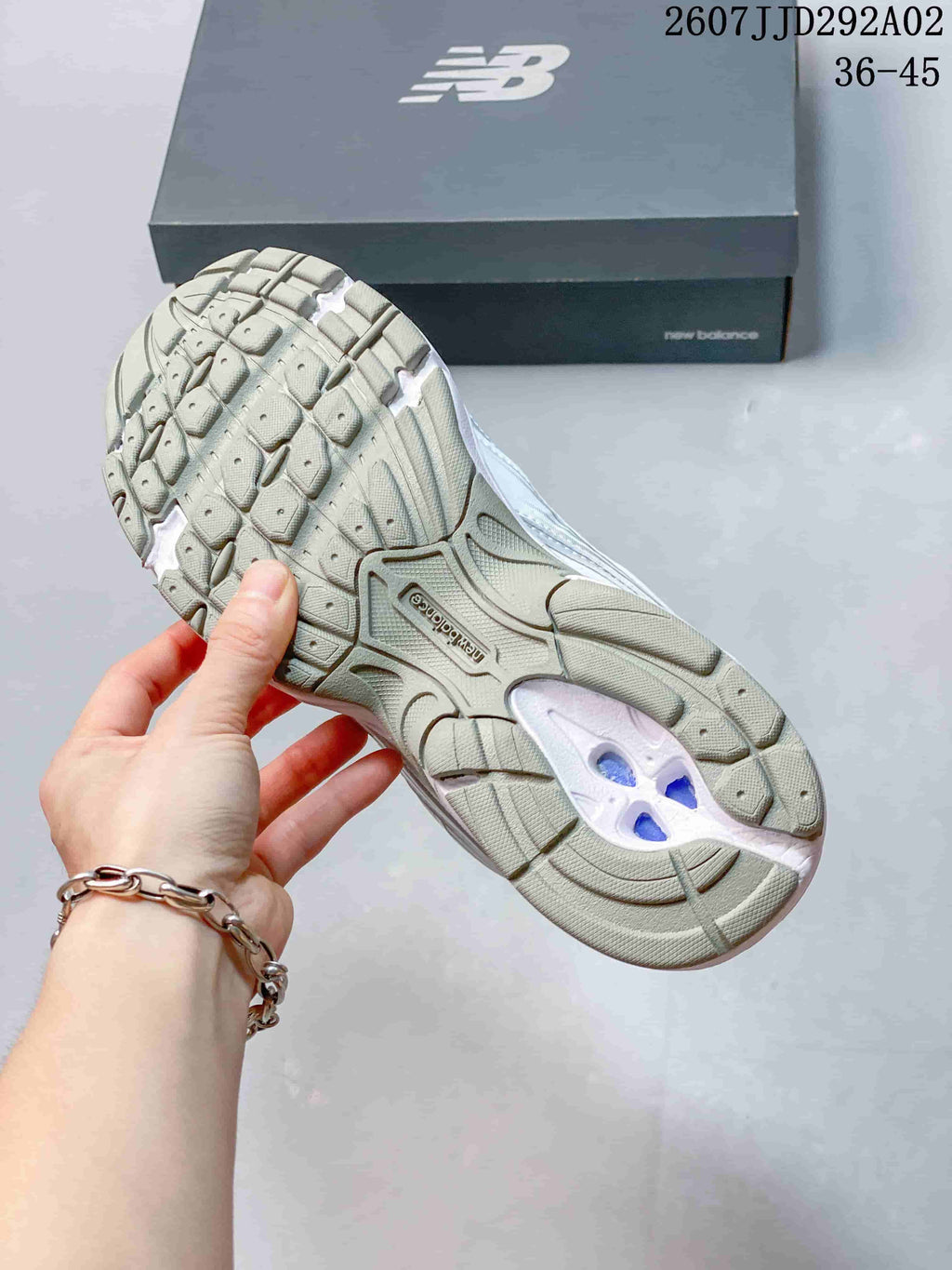 Underside view of the New Balance 509 sneaker showing the segmented tread pattern and central outsole detail.