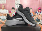 Pair of black and grey Nike sneakers shown from the side and at an angle