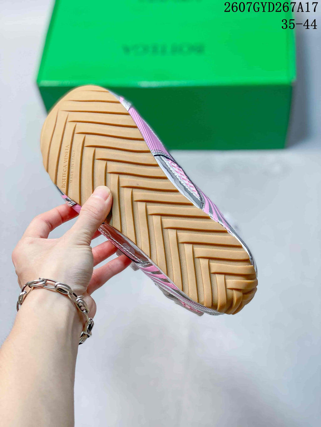 Close-up of the tan patterned outsole with embossed Bottega Veneta branding.