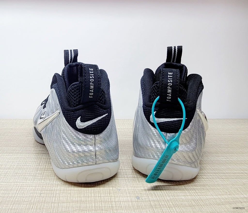 Rear view of silver and black Nike Foamposite Pro shoes