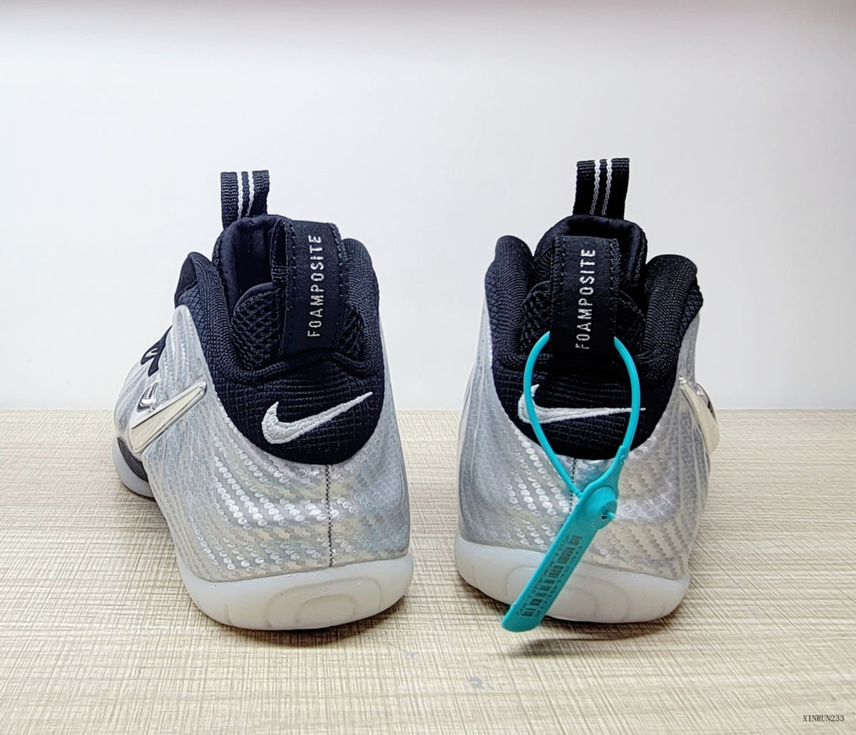Rear view of silver and black Nike Foamposite Pro shoes