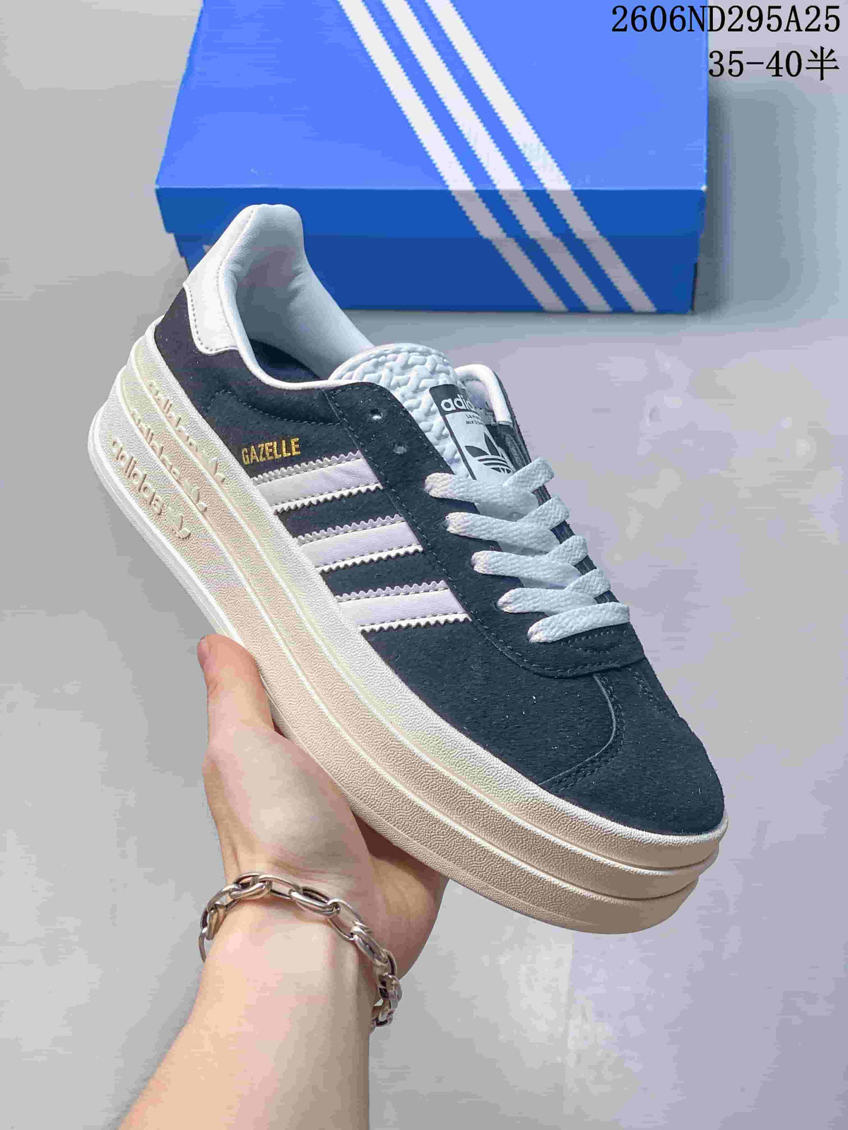 Angled side view showing the Gazelle side branding, white stripes, dark navy upper, and platform sole.