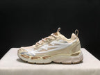 Outer side profile showing the large white arrow graphic, layered upper, and chunky cream outsole.
