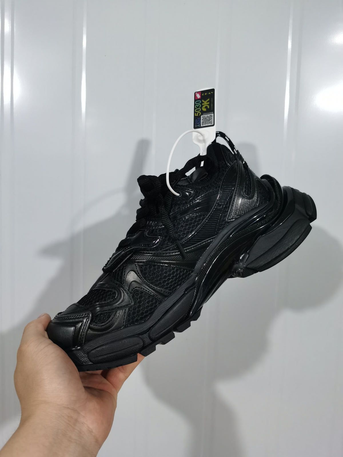 Black Puma sneaker shown from the outer side, highlighting layered panels, mesh sections, and the chunky outsole.