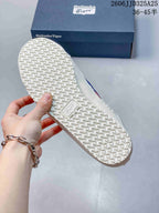 Underside of the sneaker showing the textured rubber outsole and branded outsole insert.