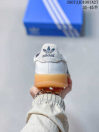 Rear view of the sneaker showing the padded heel area, adidas trefoil branding and gum-colored heel outsole.