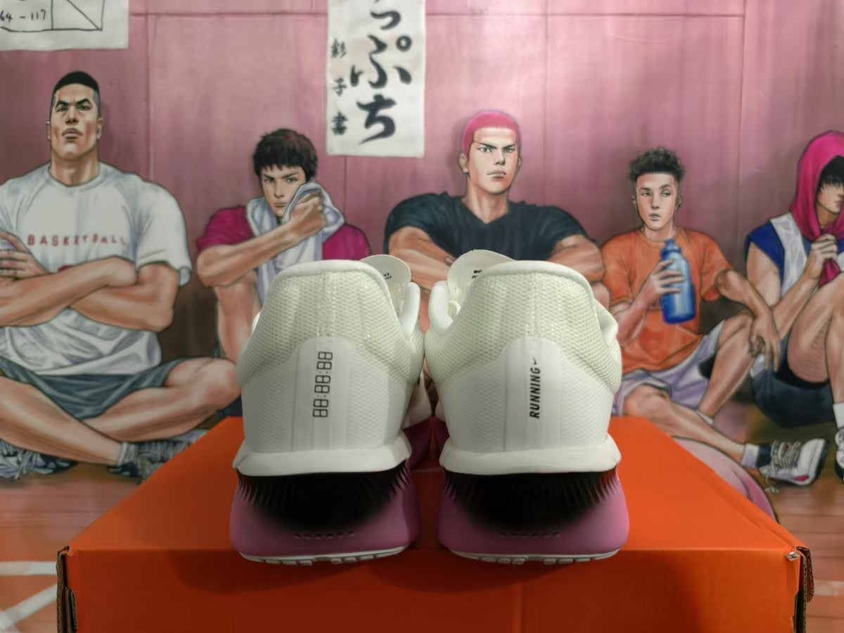 Rear view of white Nike running shoes with pink heel accents