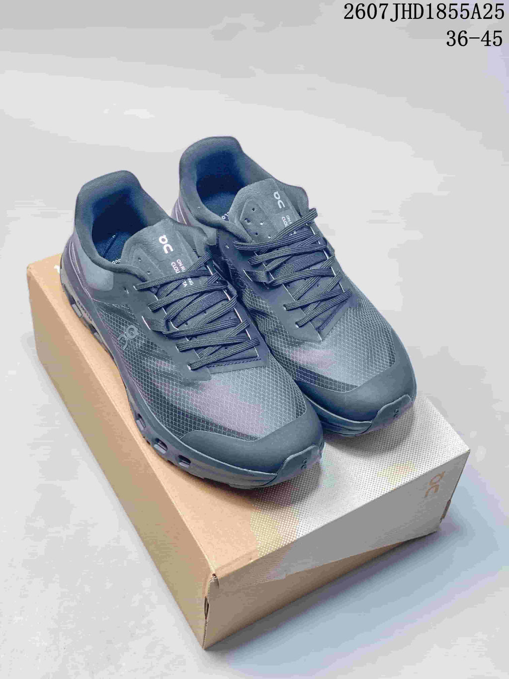 Pair of dark gray and black On Cloudvista 2 sneakers displayed on a shoebox; style code JHD1855A25 and size range 36-45 are overlaid.
