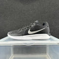 Side view of a black Nike low-top basketball sneaker with a white Swoosh and white midsole.