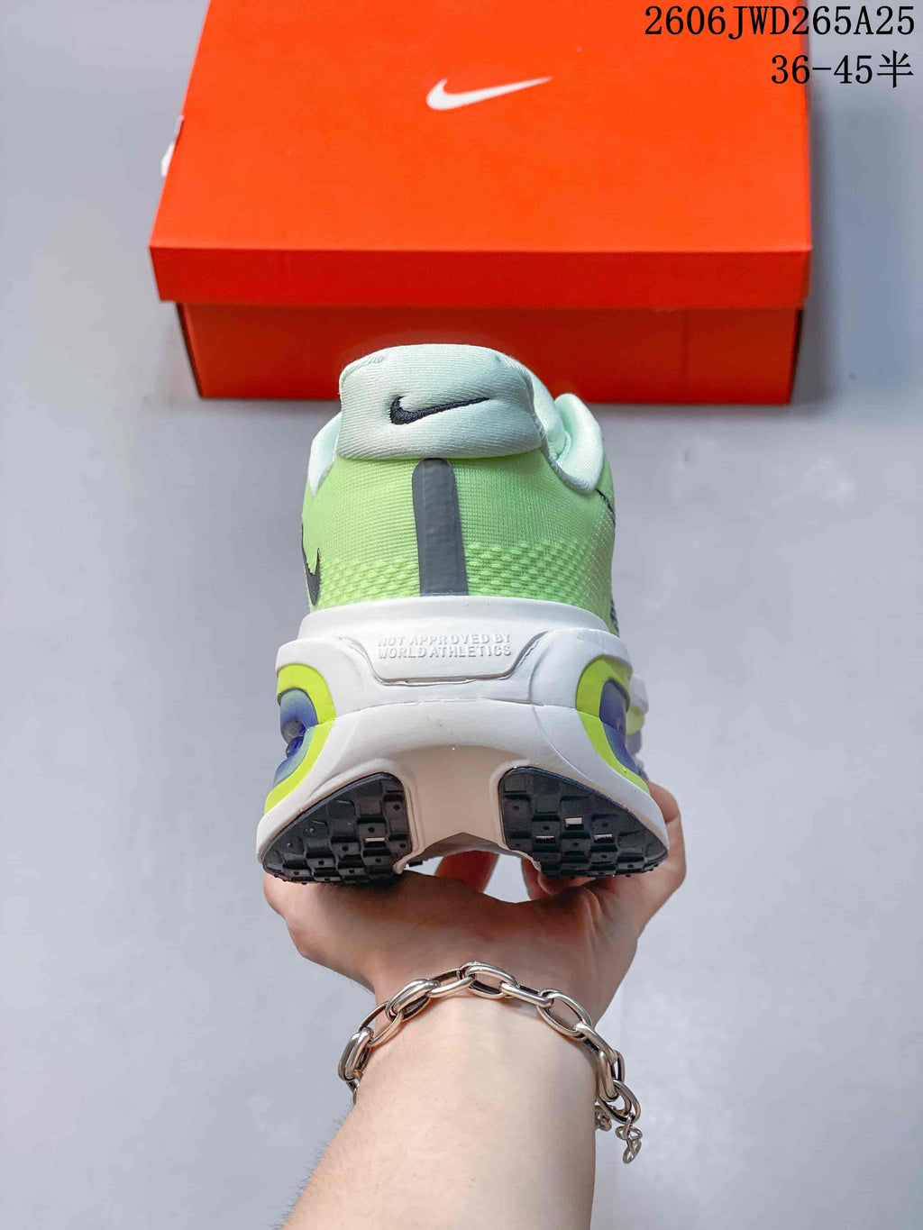 Rear view of a lime-green Nike Vomero Premium shoe with a contrasting heel and outsole.