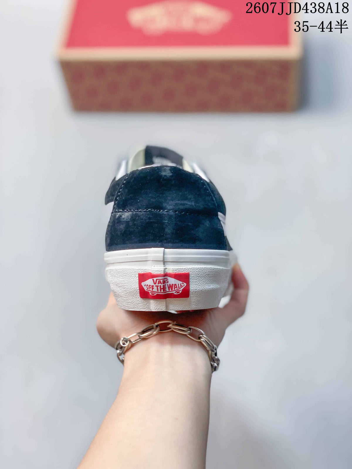 Rear view of the black low-top sneaker showing the white rubber heel and Vans branding.