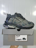 Grey Puma 1100 sneaker shown on its box, with the Runner Suede Grey label and sample size E 40 visible.