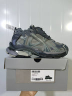 Grey Puma 1100 sneaker shown on its box, with the Runner Suede Grey label and sample size E 40 visible.
