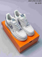 Pair of light gray low-top sneakers with patterned side details