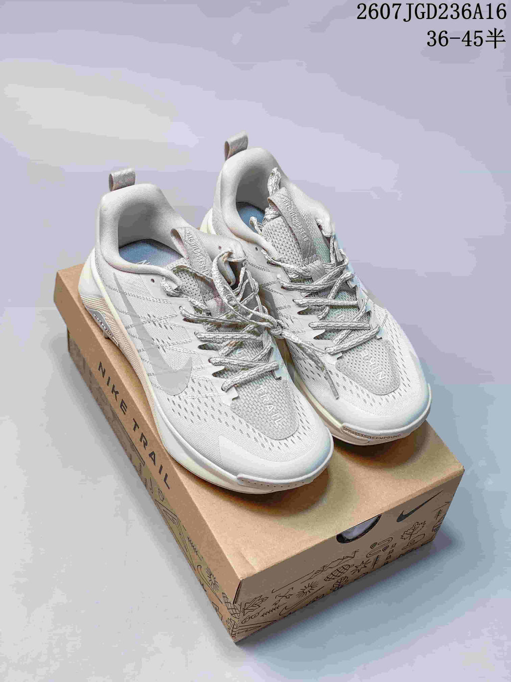 Pair of light white and gray Nike trail running shoes displayed on a branded shoe box; image text shows style code 2607JGD236A16 and size range 36–45 with half sizes.