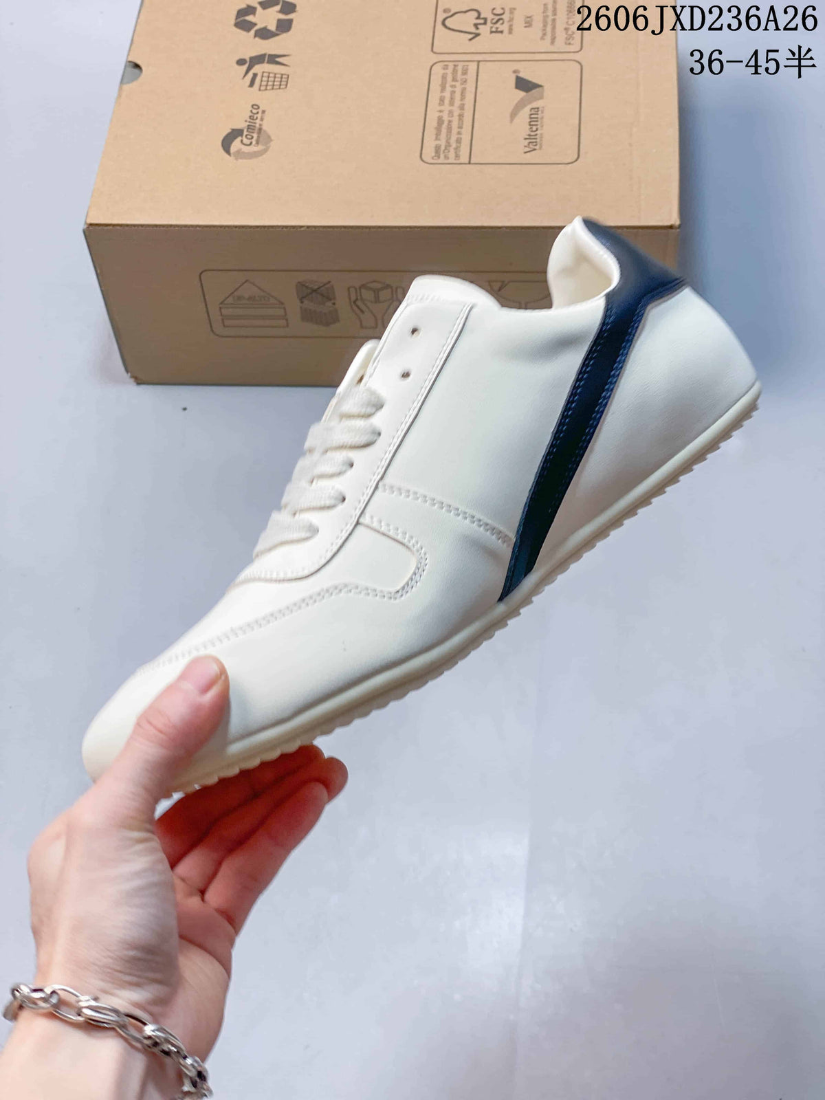 Side view of the white low-top sneaker with a navy side accent.