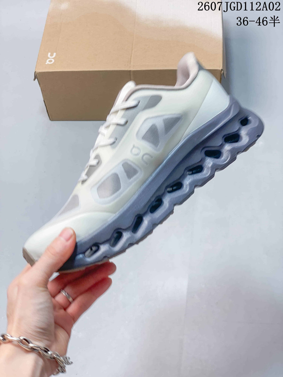 Side view showing the white and gray upper and cutout sole details
