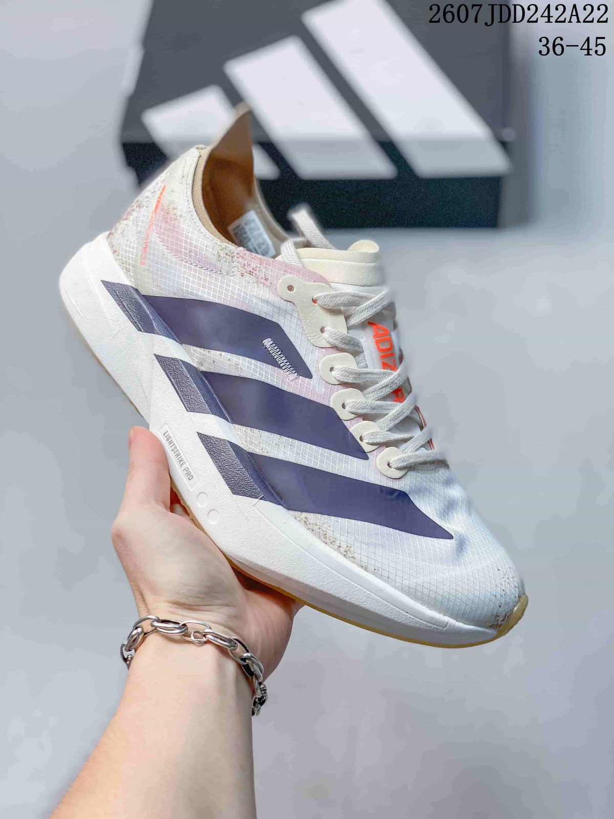 White Y-3 Adios Pro 4 sneaker with dark blue side overlays and an off-white outsole; image text shows JDD242A22 and sizes 36–45.