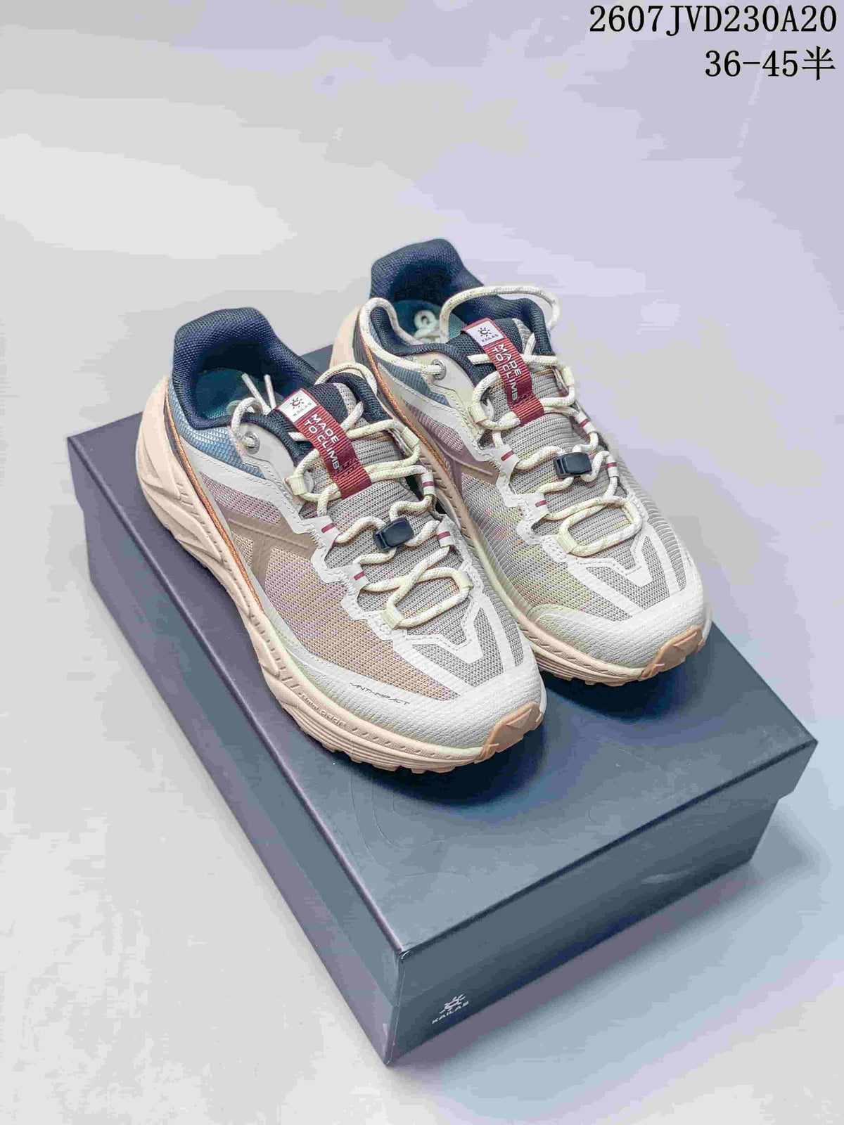 Pair of KAILAS low-top hiking shoes in off-white, gray, navy, and orange, displayed on a shoebox; image text shows style code 2607JVD230A20 and sizes 36–45 half sizes.