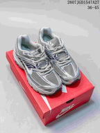 Pair of silver and grey Nike Air Max Moto 2K sneakers displayed on a red Nike shoebox.
