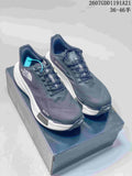 Pair of dark gray The North Face Summit sneakers displayed on a shoebox, showing the mesh uppers, white midsoles, and turquoise lace accent.