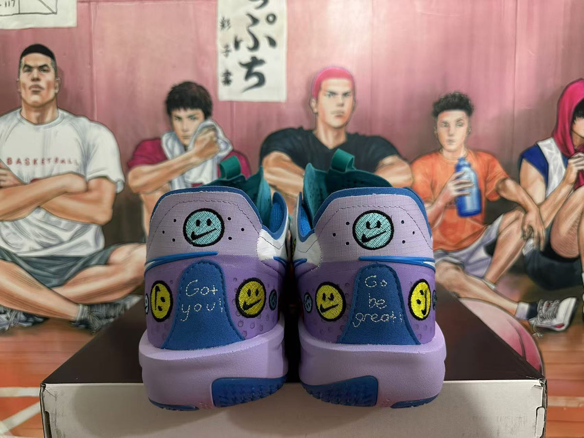 Rear view of purple and blue Nike basketball sneakers with smiley-face graphics, displayed on a shoebox.
