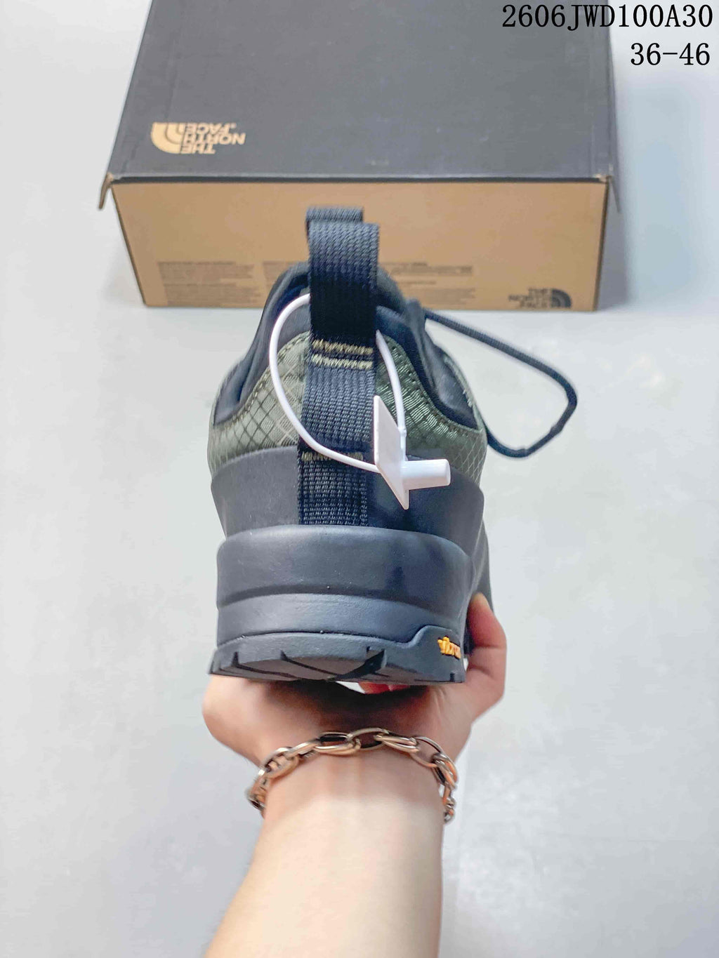 Rear view showing the heel pull tab, patterned upper, and outsole.