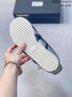 Bottom view showing the white textured outsole and black side detailing of the sneaker.